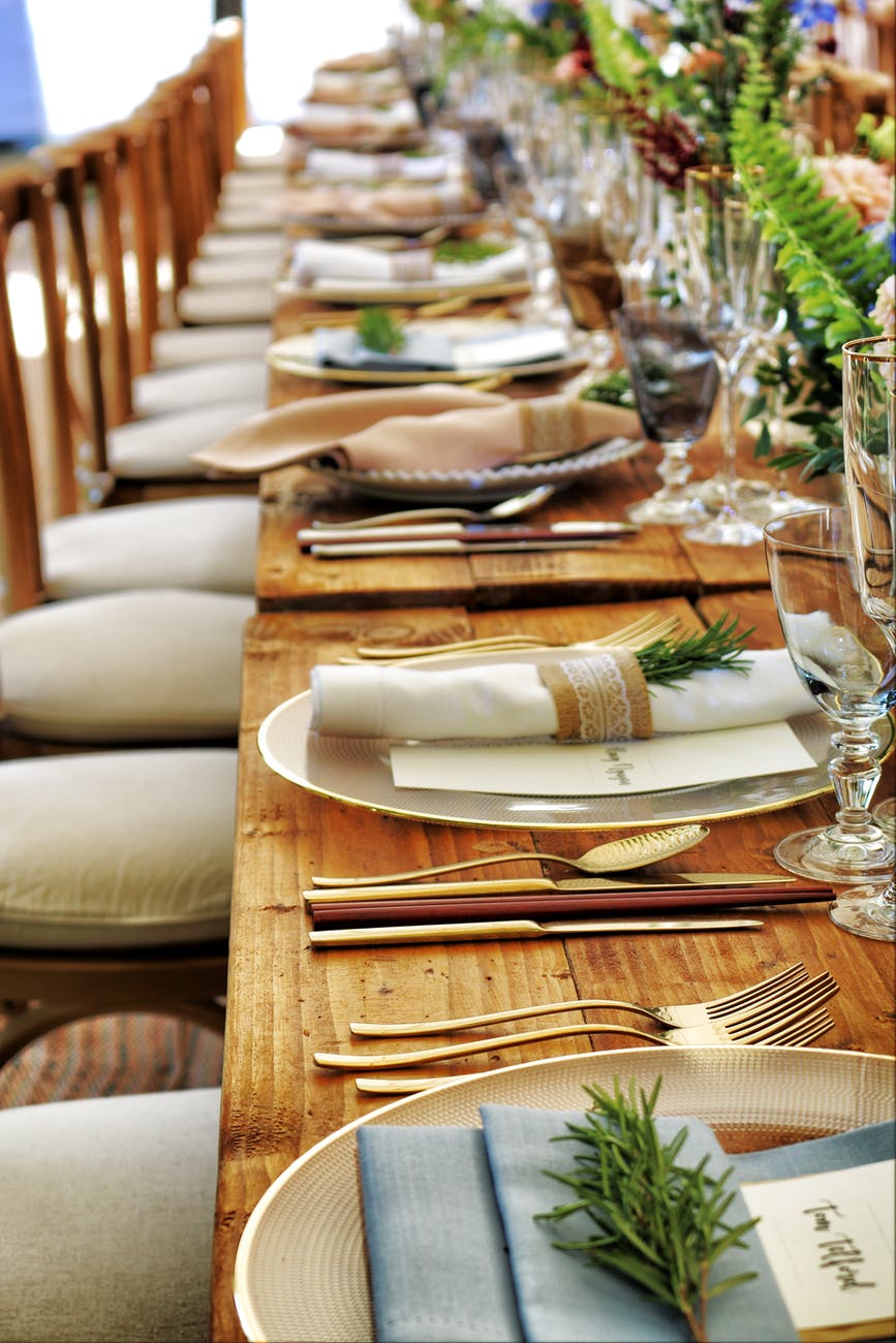 close up photo of dinnerware set on top of table with glass cups