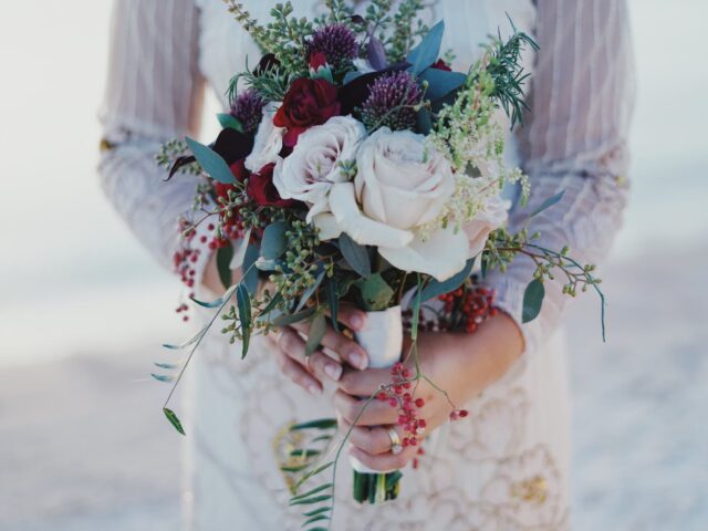 woman holding red and white rose bouquet