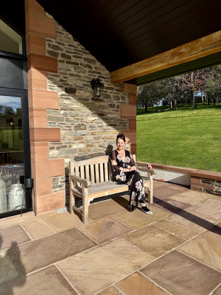Anne Marie sitting on a bench in the Lake District