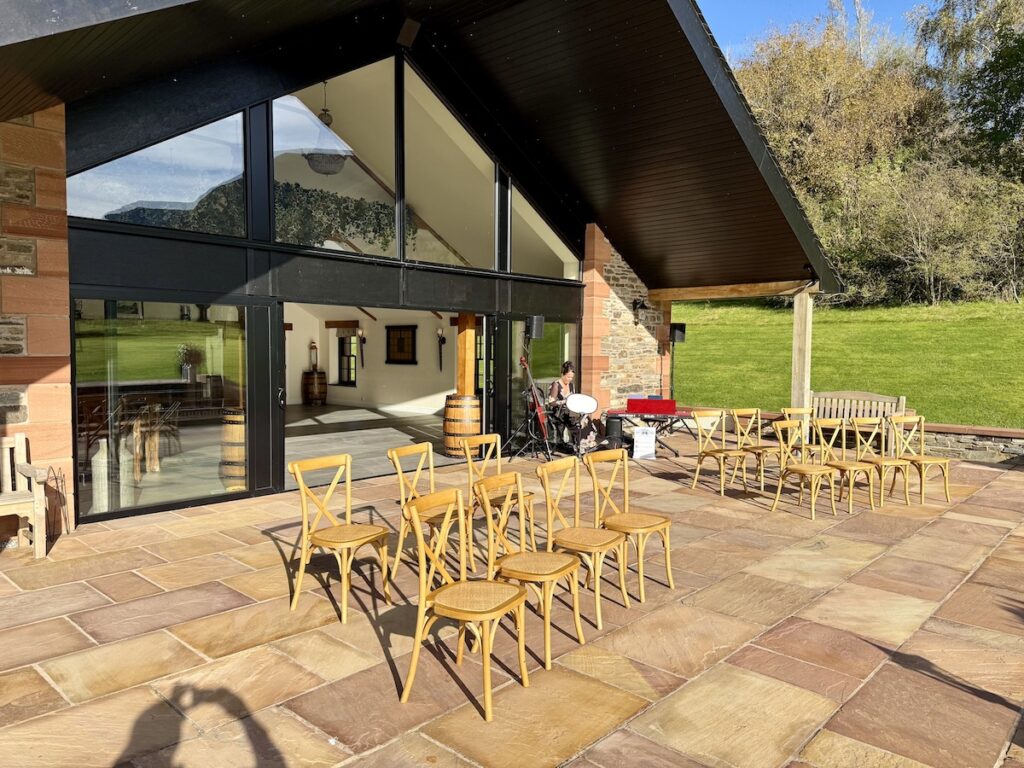 Outdoor Wedding at New House Farms with wooden chairs in the Lake District
