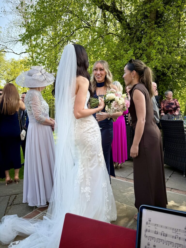 Bride at a drinks reception at Mulberry House in Essex