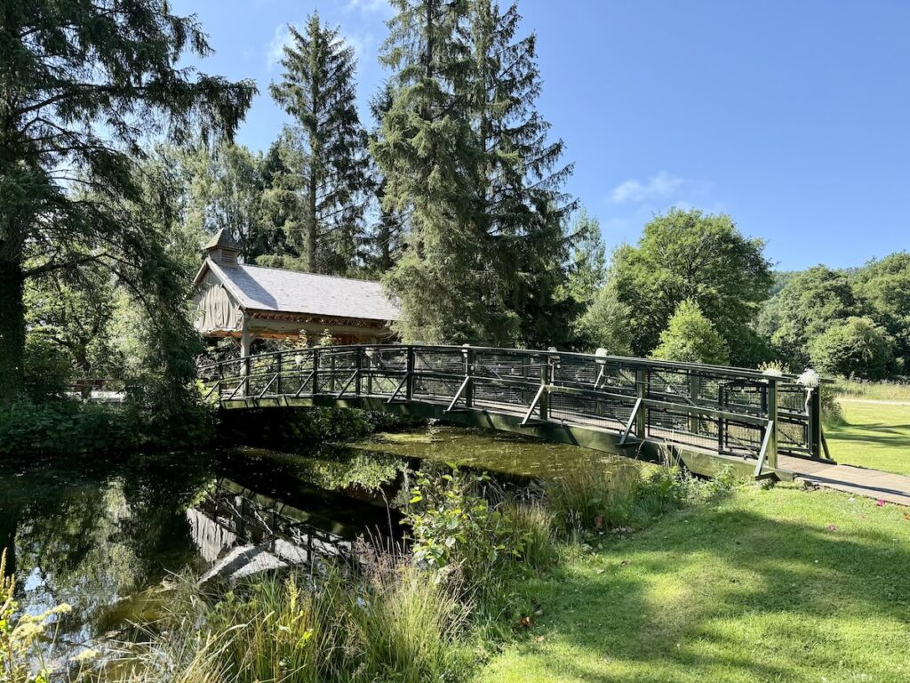 Wedding outdoor ceremony bridge to the island at Hackness Grange in Yorkshire
