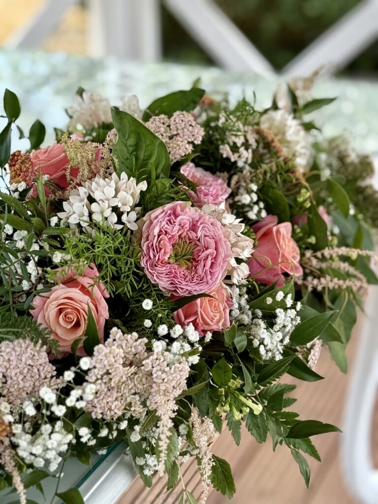 Wedding floral display with pink flowers at The Lawn, Rochford, Essex