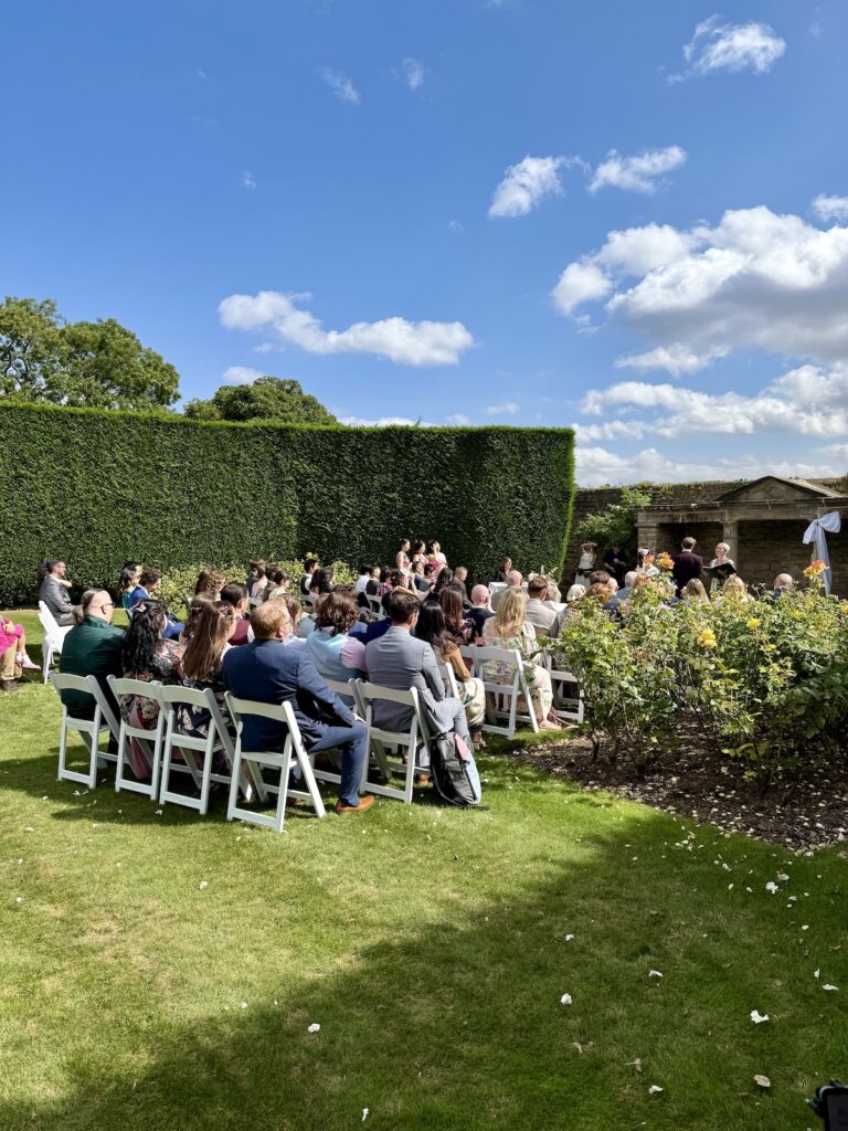 Outdoor ceremony in rose garden at Hooton Pagnell Hall in Doncaster South Yorkshire.