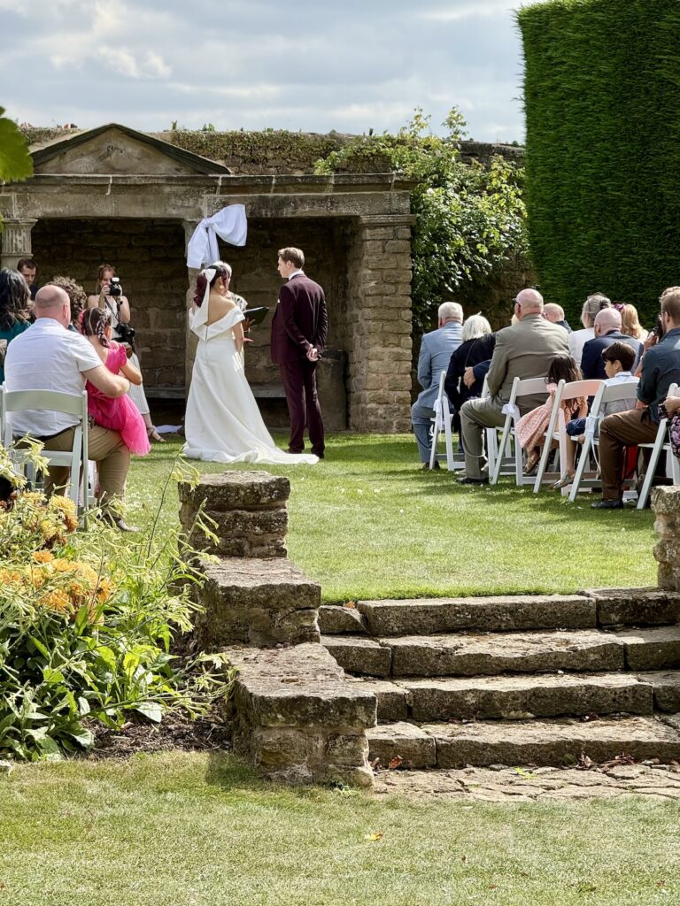 Wedding couple outdoor ceremony at Hooton Pagnell Hall in Doncaster South Yorkshire.