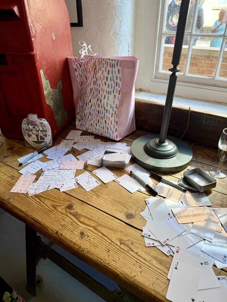 Sign a playing card at the West Mill Wedding Venue in Derby
