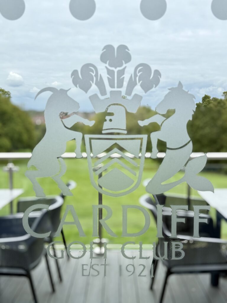 Window etched sign with view over course at Cardiff Golf Club in South Wales.