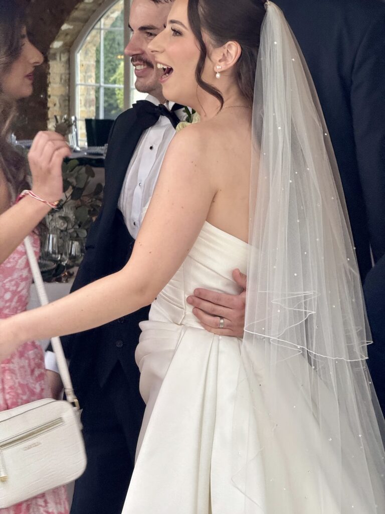 Bride and Groom - greeting guests at Friern Manor in Essex