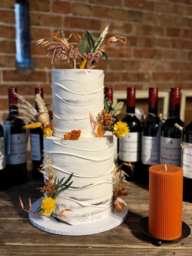 Wedding cake surrounded by wine bottles at the Pheasantry Brewery near Newark in Nottinghamshire.