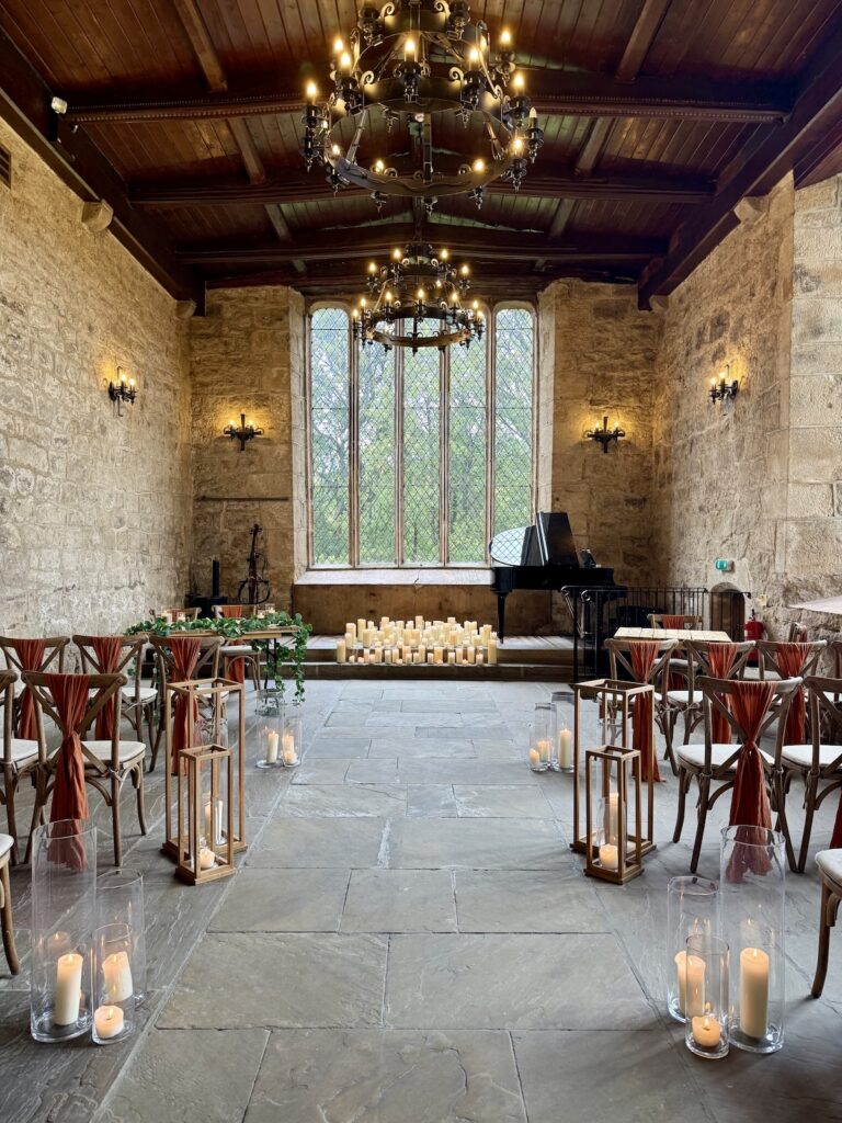 Ceremony room with candles and grand piano at the Priests House in Skipton