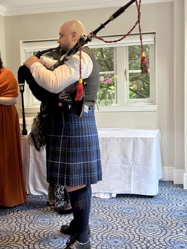 Scottish Piper wearing kilt at Balbirnie House in Scotland