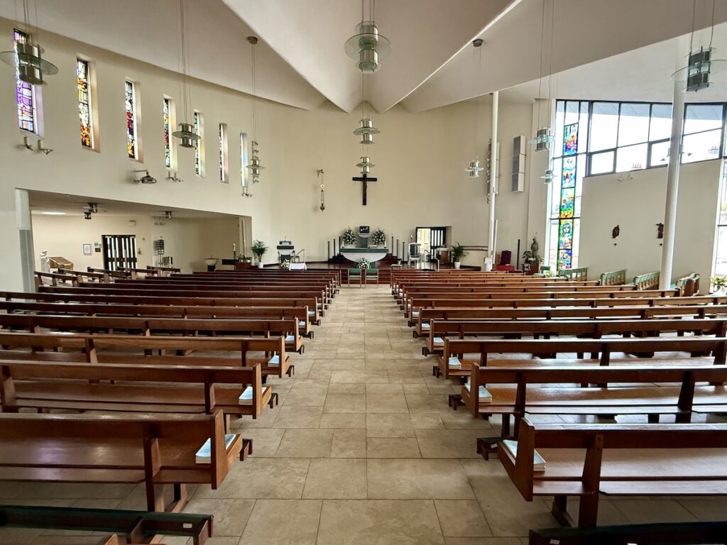Church interior with flowers for wedding at St Joseph's RC Church in Clarkston, Glasgow, Scotland