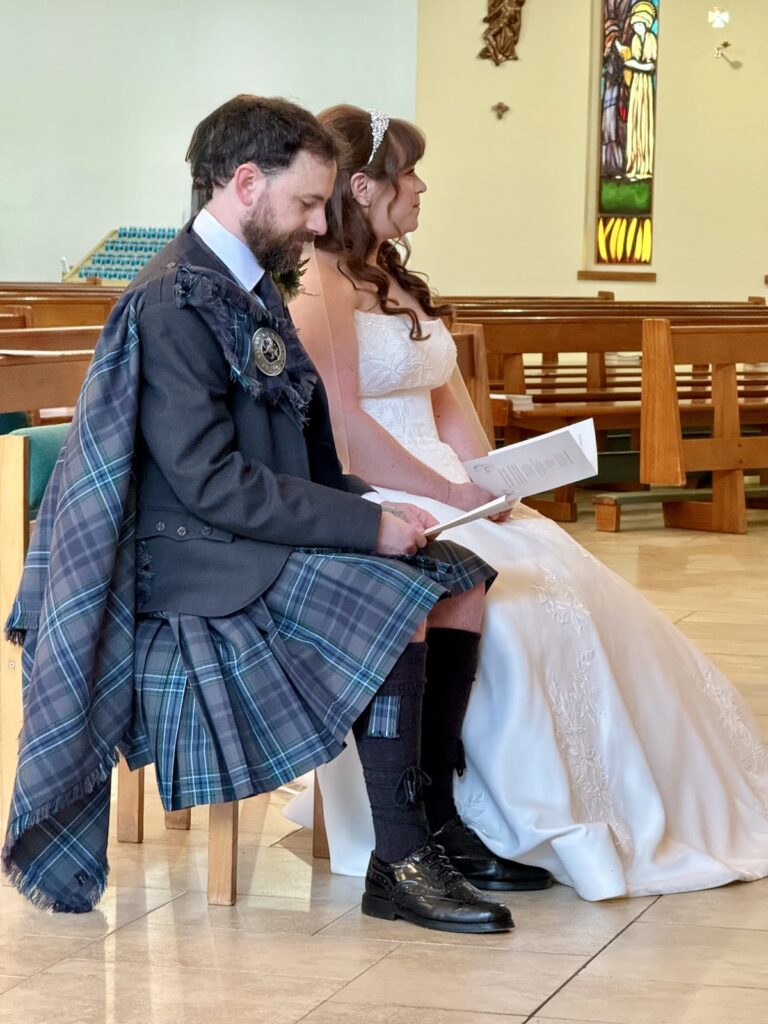 Bride and Groom with groom in kilt at St Joseph's RC Church in Clarkston, Glasgow, Scotland