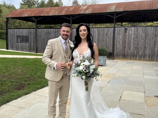 Bride and Groom outside the main wedding barn at Old Gore in Cirencester.
