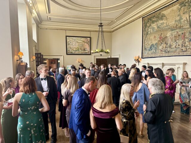 Wedding guests during drinks reception indoors at Elmore Court in Gloucestershire and the Cotswolds