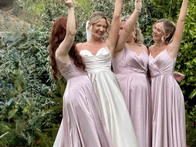 Bride with bridesmaids outside at Polhawn Fort in Cornwall