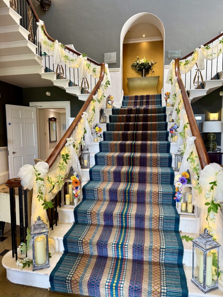 Staircase with floral decoration at Rudding Park Hotel near Harrogate