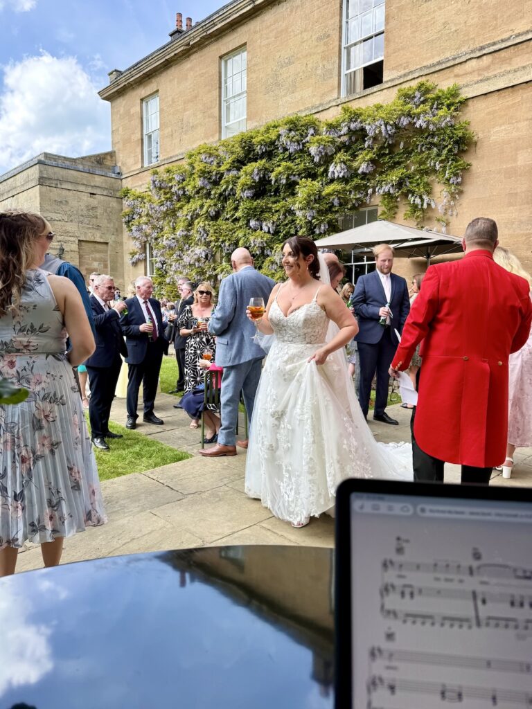 Bride and Toastmaster outside in the sunshine at Rudding Park Hotel near Harrogate