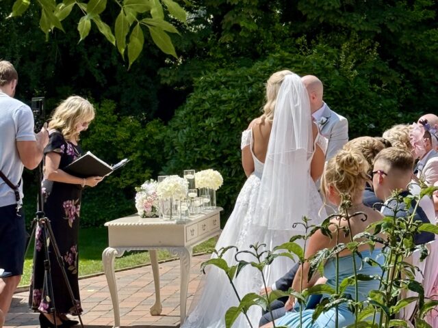 Bride and Groom during their wedding ceremony outdoors at Woodlands Hall Hotel in Leeds with Daytime music by Cello and Piano Duo JAM Duo