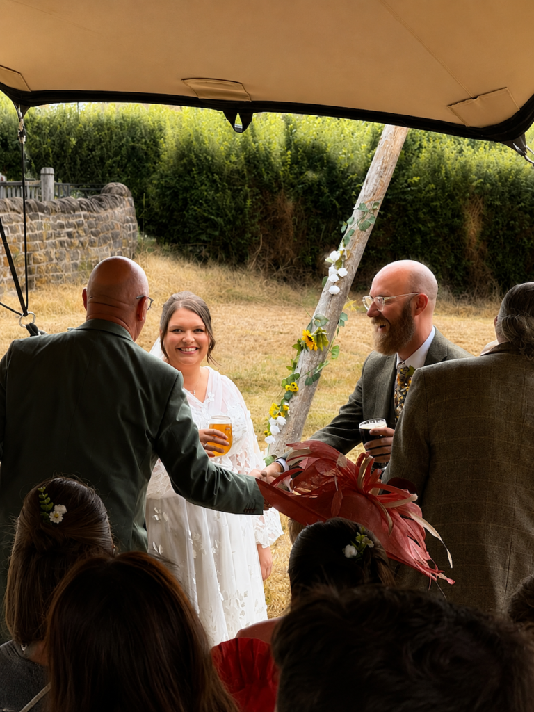 Outdoor wedding ceremony beneath a stretch tent at The Orchard at Munsley in Herefordshire