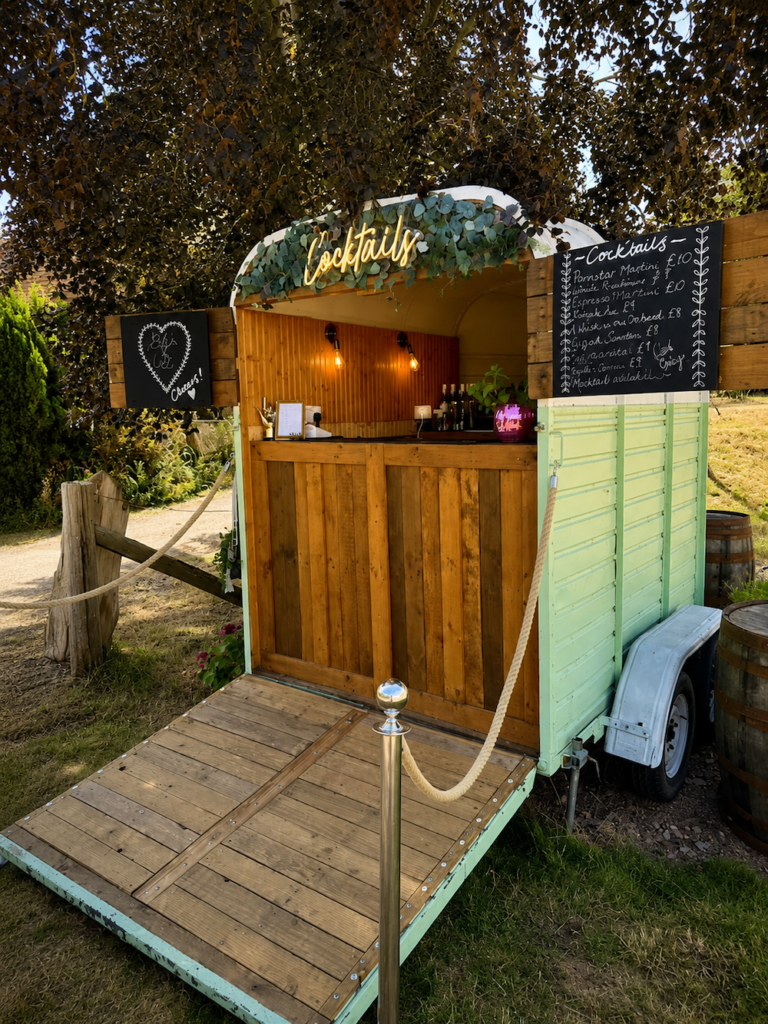 Wedding drinks reception setting overlooking the gardens and orchard at The Orchard at Munsley