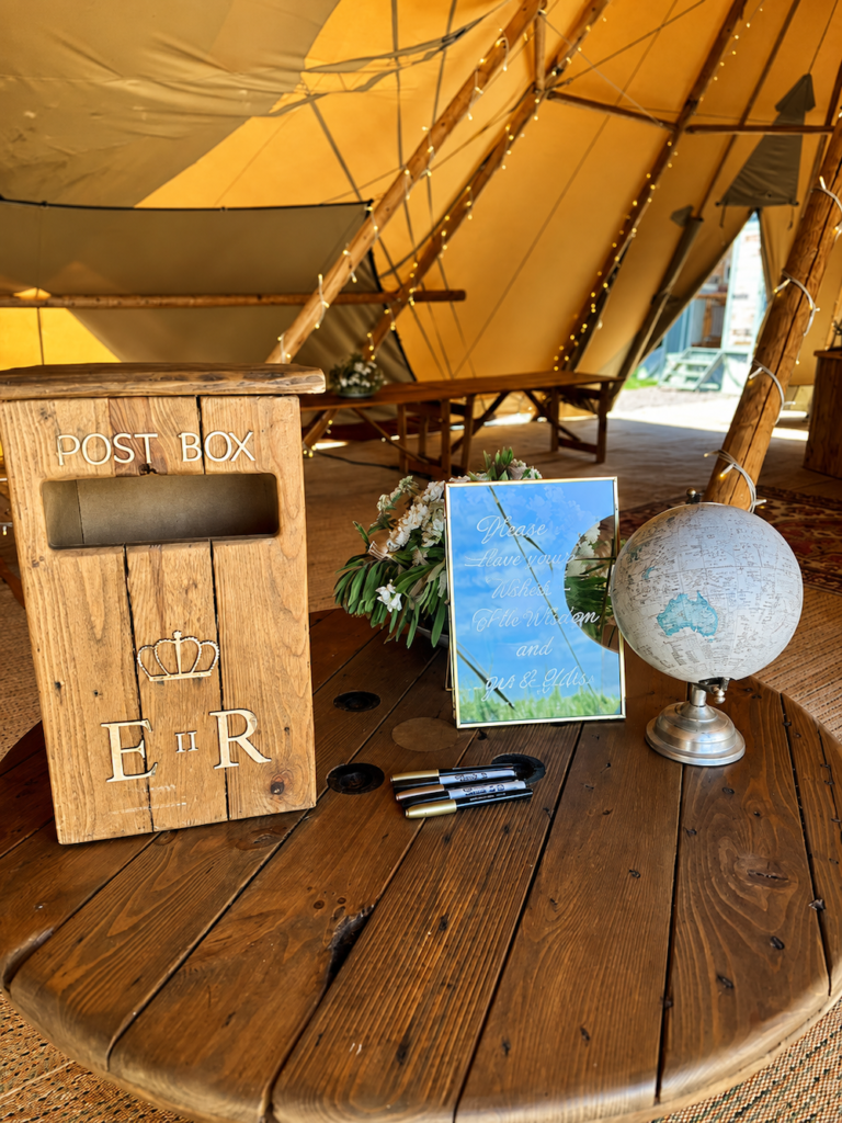 Wooden wedding post box and guest message station inside the stretch tent