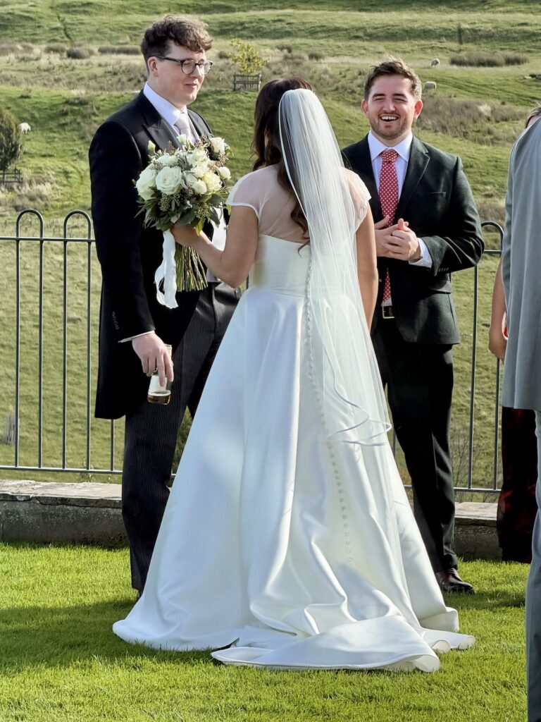 Bride and Groom outdoor drinks reception for wedding at Kingscote barn in The Cotswolds